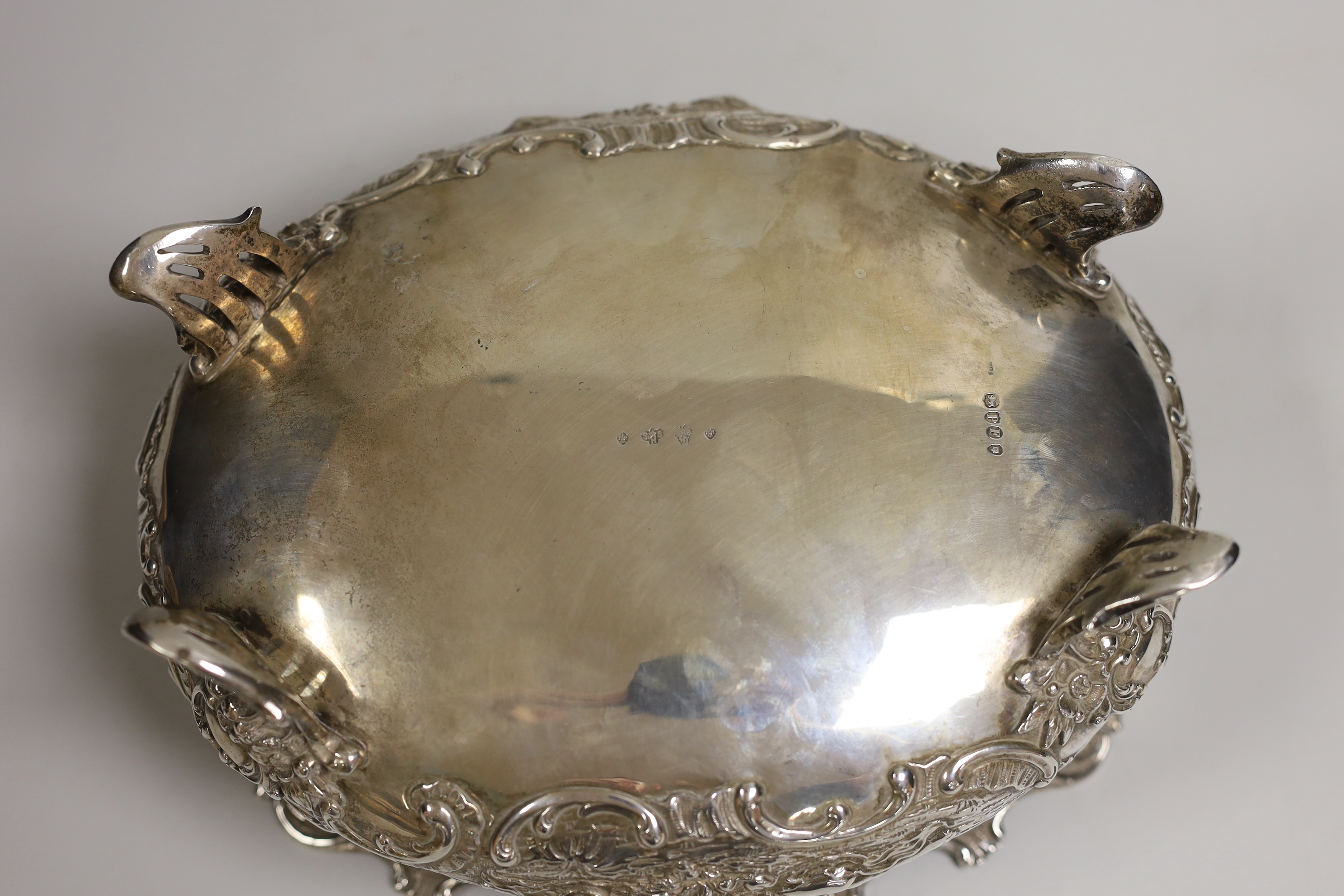 An ornate late 19th century German embossed silver oval fruit bowl, with pierced scroll feet, import marks for London, 1890, length 23.9cm, 30oz.